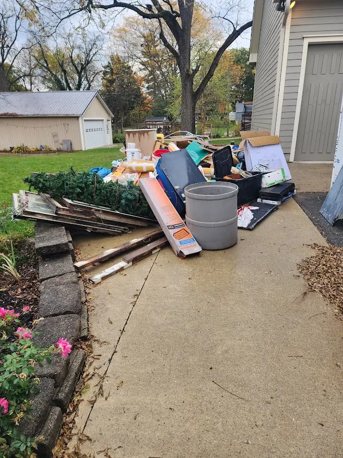 Dumpster being loaded with debris for Commercial Dumpster Rental in Milton